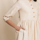 Front Detail of a Model wearing Dusk Beige Warm Cotton Striped Gathered Midi Dress
