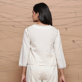 Back View of a Model wearing Undyed V Neck Jute Laced Cotton Top