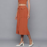 Left View of a Model wearing Sunset Rust Button-Down Midi Skirt