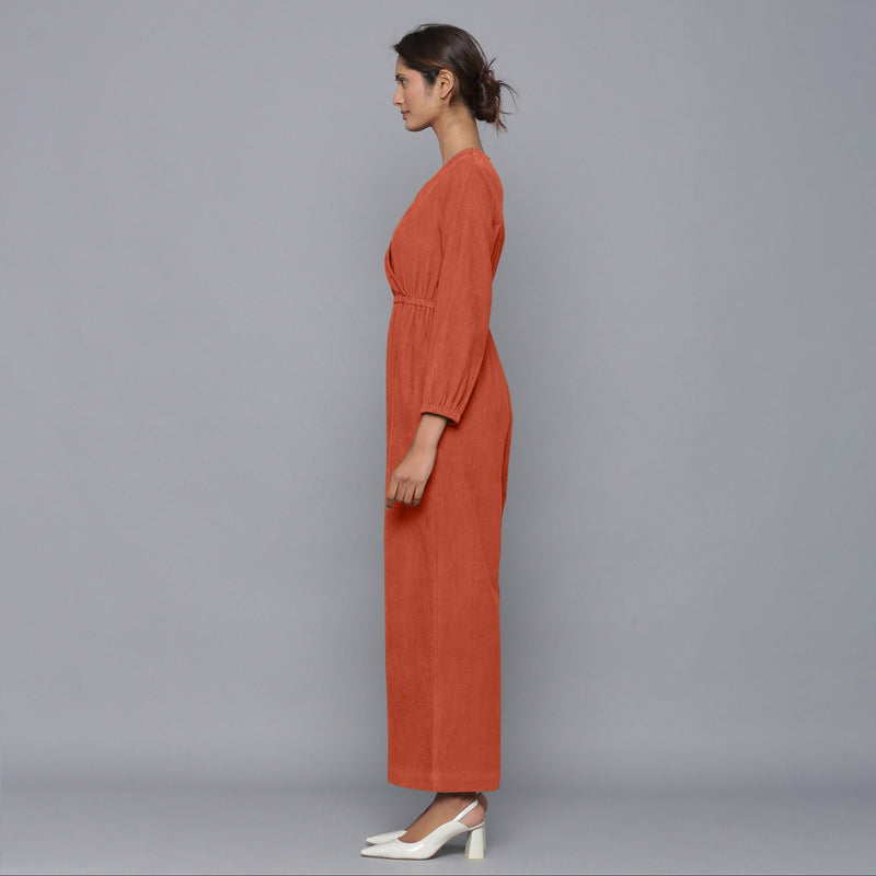 Left View of a Model wearing Sunset Rust Corduroy Comfy Jumpsuit