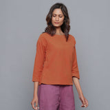 Front View of a Model wearing Sunset Rust Corduroy Drop Shoulder Top