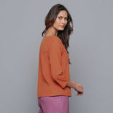 Right View of a Model wearing Sunset Rust Corduroy Drop Shoulder Top
