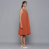 Right View of a Model wearing Sunset Rust Corduroy Flared Dress