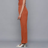 Left View of a Model wearing Sunset Rust Corduroy Striped Bootcut Pant