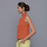 Left View of a Model wearing Sunset Rust Cotton Corduroy High Neck Top