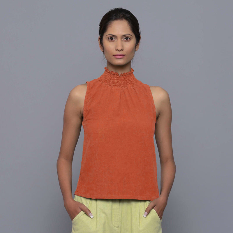 Front View of a Model wearing Sunset Rust Cotton Corduroy High Neck Top