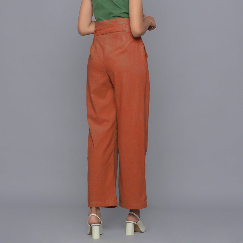 Back View of a Model wearing Sunset Rust Cotton Corduroy Pant