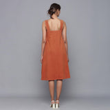 Back View of a Model wearing Sunset Rust Corduroy Flared Dress