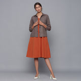 Front View of a Model wearing Sunset Rust Dress and Ash Grey Jacket Set