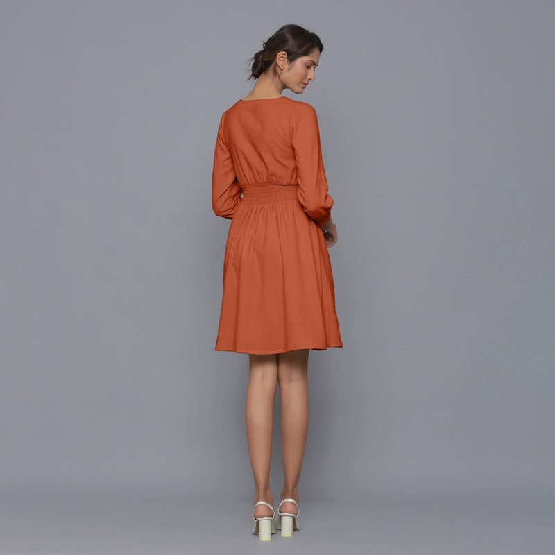 Back View of a Model wearing Sunset Rust V-Neck Corduroy Dress
