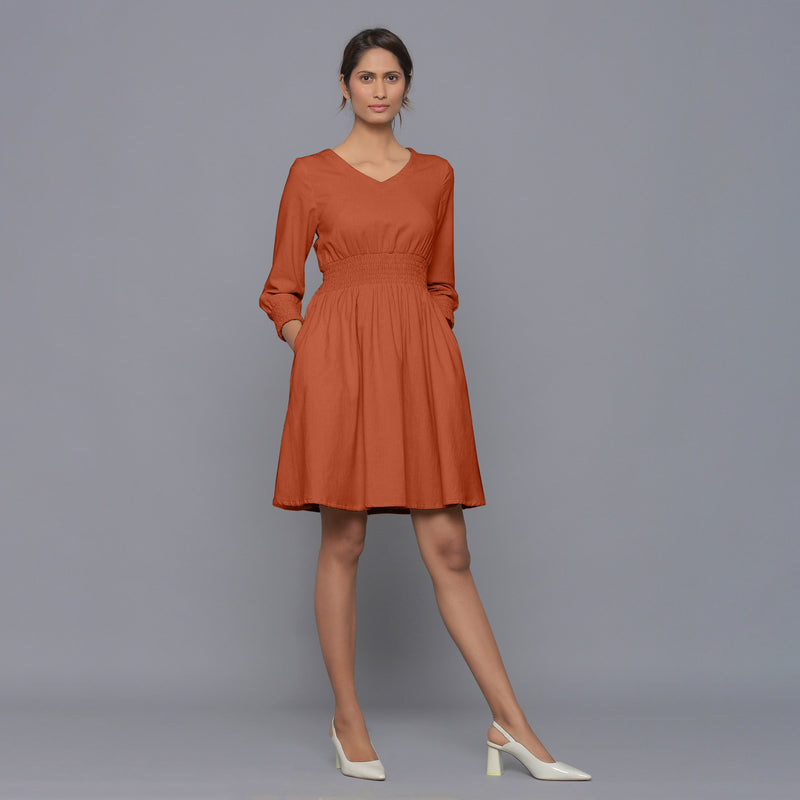 Front View of a Model wearing Sunset Rust V-Neck Corduroy Dress