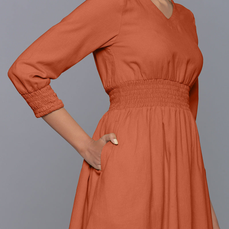 Front Detail of a Model wearing Sunset Rust V-Neck Corduroy Dress