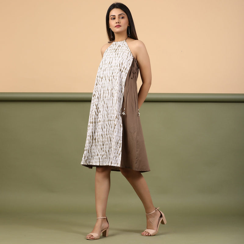 Left View of a Model wearing Taupe Tie-Dye Cotton Knee Length Halter Neck Dress