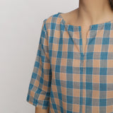 Front Detail of a Model wearing Green and Brown Checkered Tunic Top