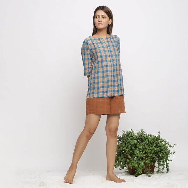 Front View of a Model wearing Green and Brown Checkered Tunic Top