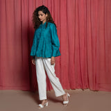 Left View of a Model wearing Teal Cotton Chanderi Balloon Sleeves Tier Top