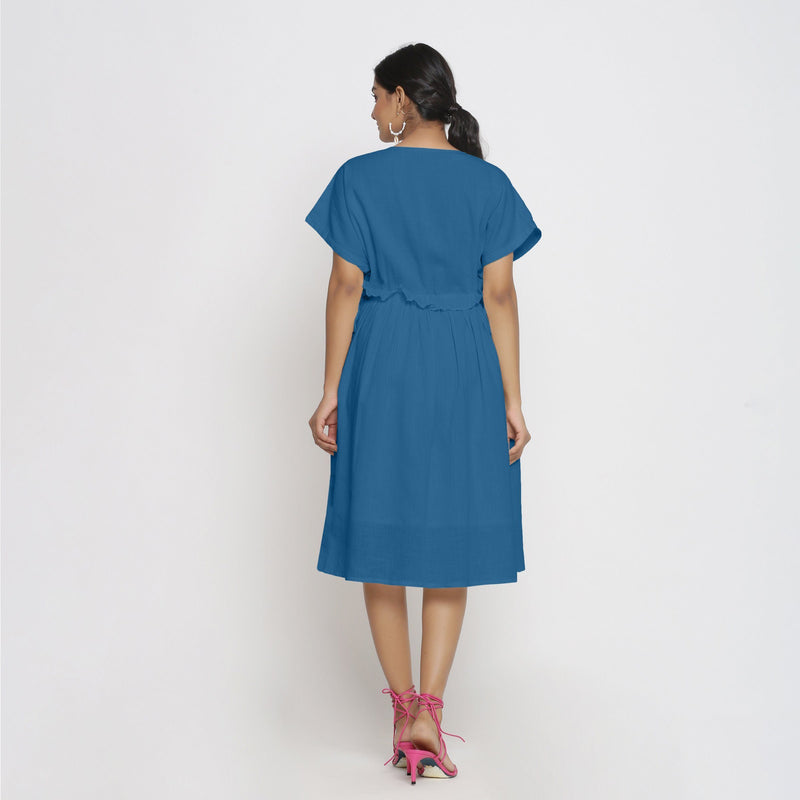 Back View of a Model wearing Teal Deep Neck Bohemian Frilled Dress