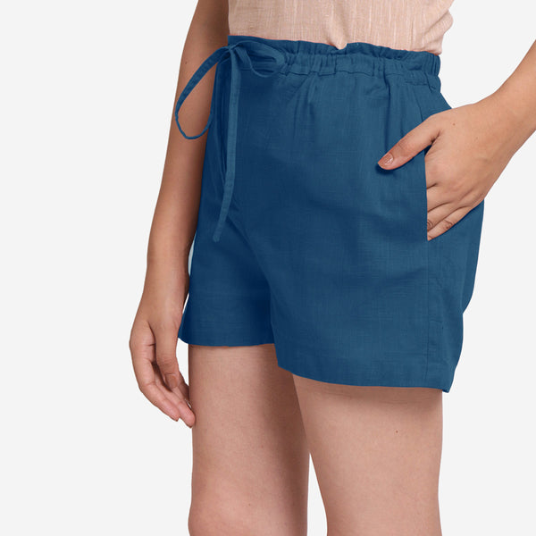 Left View of a Model wearing Teal Mid-Rise Cotton Straight Shorts