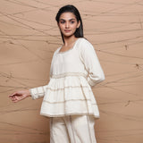 Left View of a Model wearing Undyed Cotton Jute Laced Peplum Top