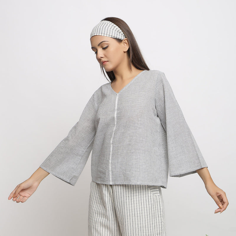 Left View of a Model wearing Off-White Handwoven Cotton V-Neck Top