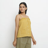 Right View of a Model wearing Light Yellow Patch Pocket Vegetable Dyed Handspun Cotton Camisole Top
