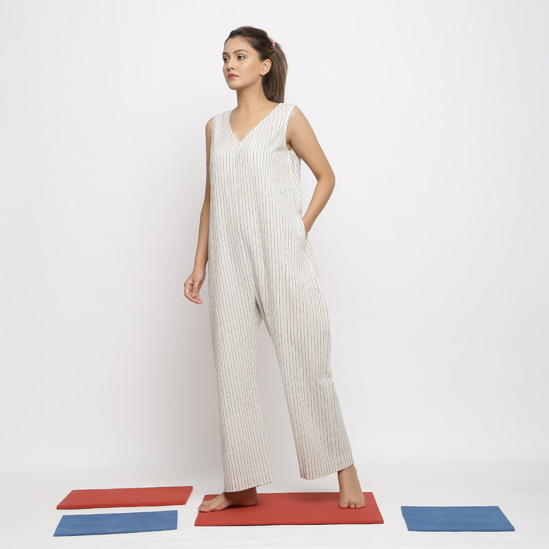 Left View of a Model wearing Ecru and Blue Striped Vegetable Dyed Cotton Sleeveless Jumpsuit