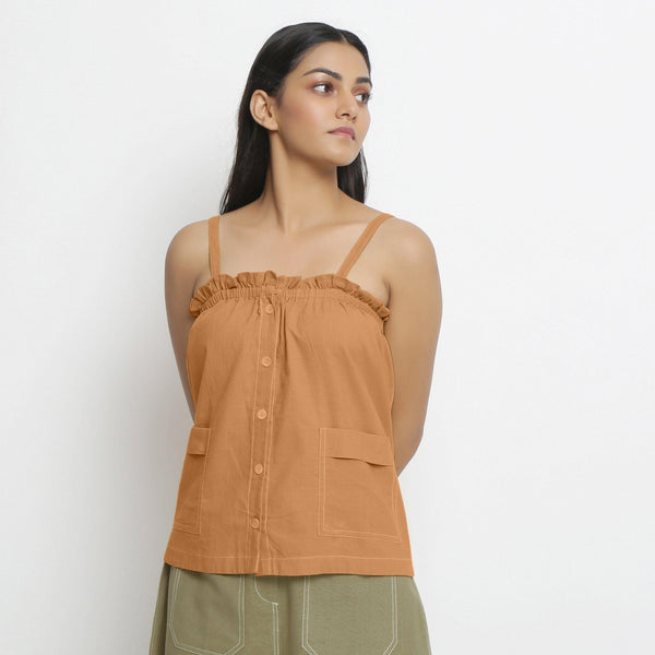 Front View of a Model wearing Vegetable-Dyed Orange 100% Cotton Button-Down Top