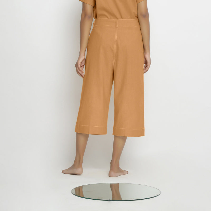 Back View of a Model wearing Vegetable Dyed Orange 100% Cotton Mid-Rise Culottes