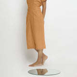 Left View of a Model wearing Vegetable Dyed Orange 100% Cotton Mid-Rise Culottes