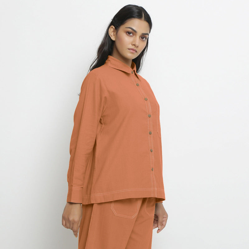 Right View of a Model wearing Vegetable Dyed Orange Button-Down Top
