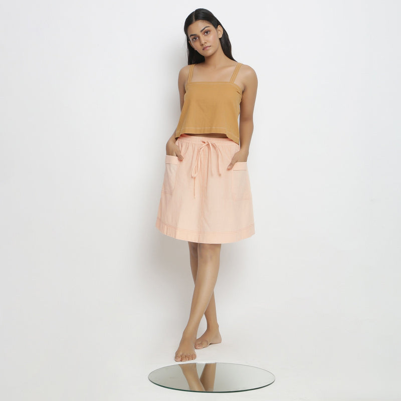 Front View of a Model wearing Powder Pink Vegetable Dyed Cotton Elasticated Mid-Rise Short Skirt