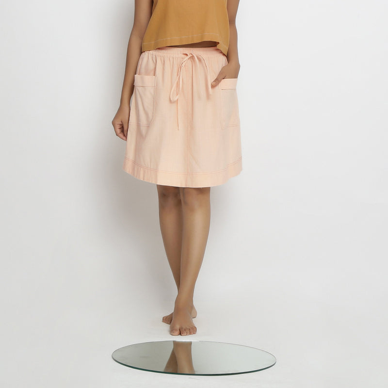 Front View of a Model wearing Powder Pink Vegetable Dyed Cotton Elasticated Mid-Rise Short Skirt