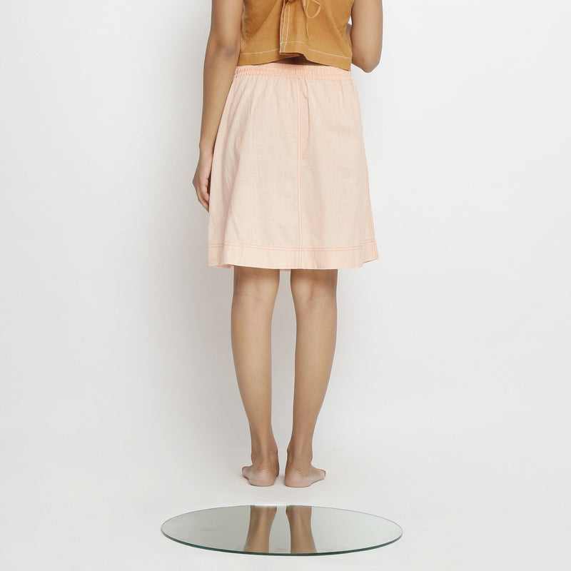 Back View of a Model wearing Powder Pink Vegetable Dyed Cotton Elasticated Mid-Rise Short Skirt