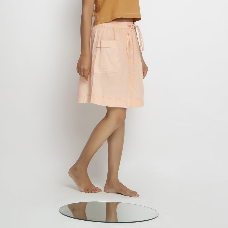 Right View of a Model wearing Powder Pink Vegetable Dyed Cotton Elasticated Mid-Rise Short Skirt