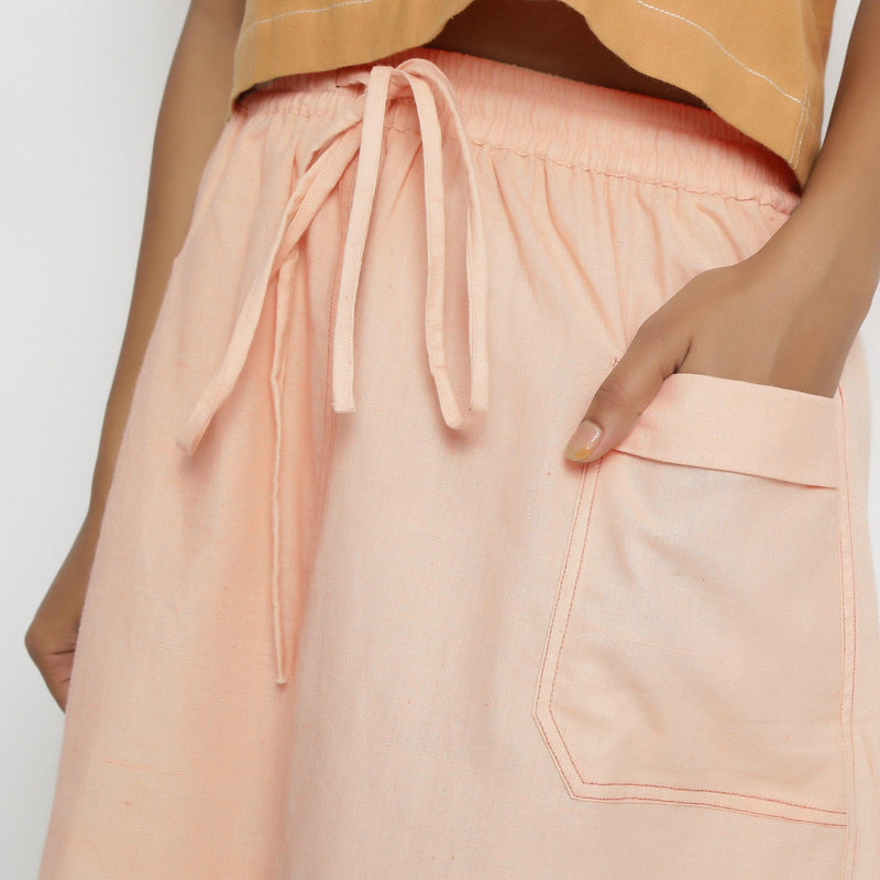 Front Detail of a Model wearing Powder Pink Vegetable Dyed Cotton Elasticated Mid-Rise Short Skirt