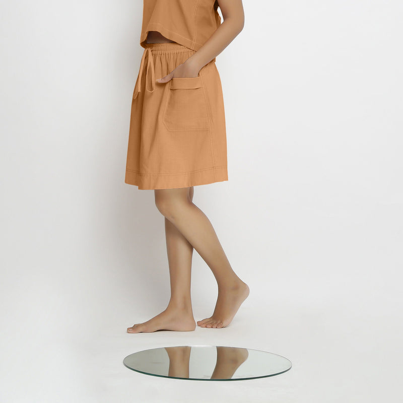Left View of a Model wearing Vegetable-Dyed Rust 100% Cotton Mid-Rise Skirt
