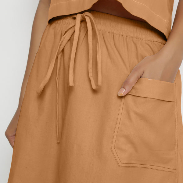 Front Detail of a Model wearing Vegetable-Dyed Rust 100% Cotton Mid-Rise Skirt