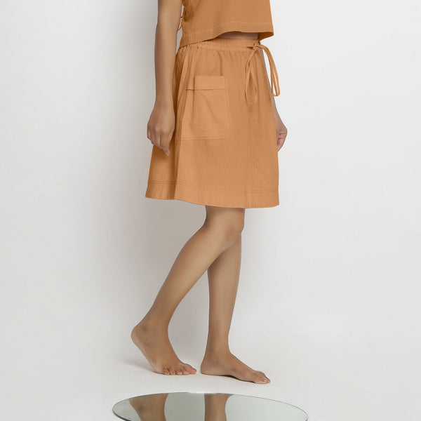 Right View of a Model wearing Vegetable-Dyed Rust 100% Cotton Mid-Rise Skirt