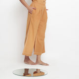 Right View of a Model wearing Rust Vegetable Dyed Cotton Elasticated Wide Legged Pant