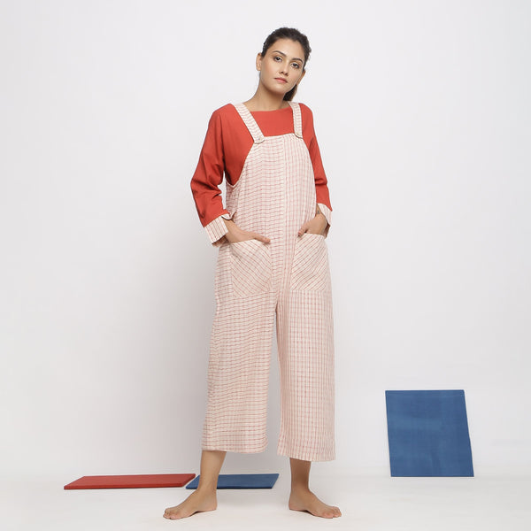 Front View of a Model wearing Ecru and Brick Red Striped Vegetable Dyed Cotton Pinafore Jumpsuit
