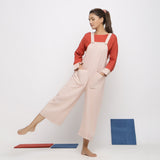 Front View of a Model wearing Ecru and Brick Red Striped Vegetable Dyed Cotton Pinafore Jumpsuit