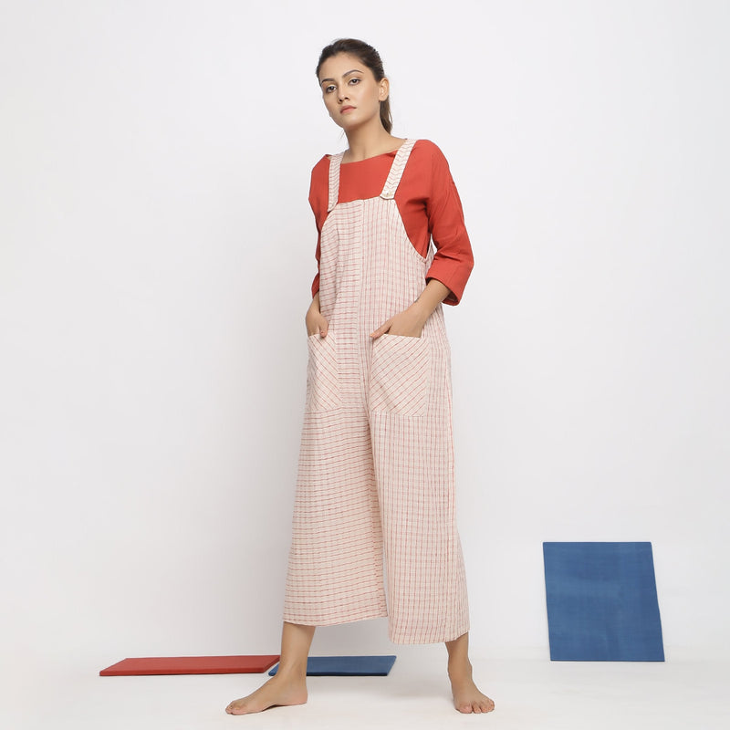 Left View of a Model wearing Ecru and Brick Red Striped Vegetable Dyed Cotton Pinafore Jumpsuit