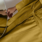 Close View of a Model wearing Vegetable-Dyed Yellow 100% Cotton Paneled Overlay