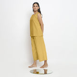 Left View of a Model wearing Vegetable Dyed yellow Boat Neck A-Line Top