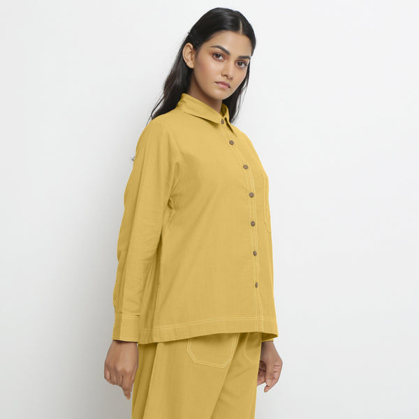 Right View of a Model wearing Vegetable Dyed Yellow Button-Down Cotton Top