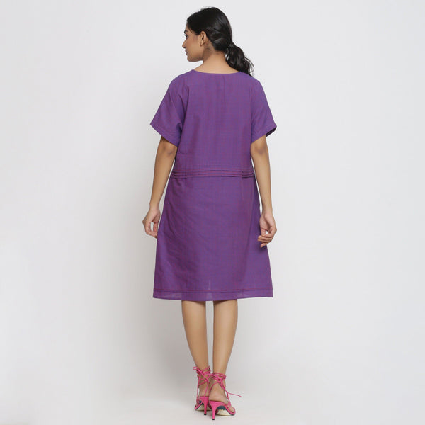 Back View of a Model wearing Violet Cotton V-Neck Pleated Dress