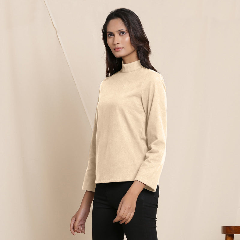 Left View of a Model wearing Warm Beige Turtle Neck Straight Top