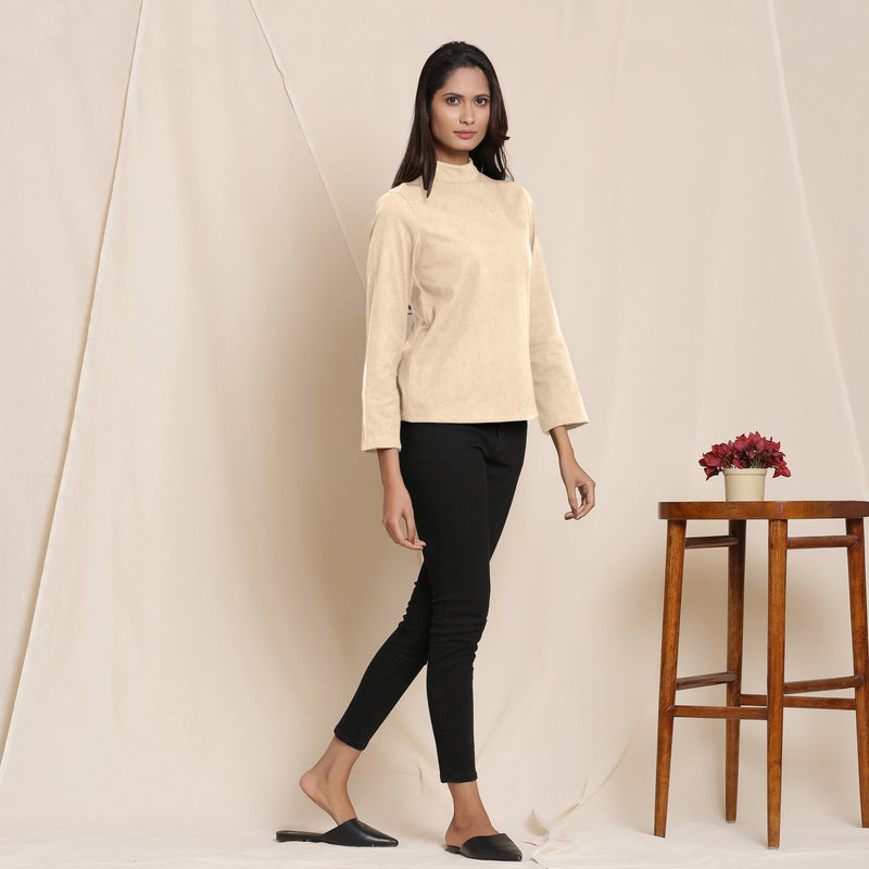 Right View of a Model wearing Warm Beige Turtle Neck Straight Top