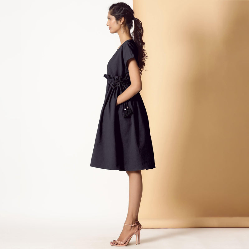 Left View of a Model wearing Black Warm Cotton Flannel Knee Length Frilled Dress