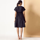 Back View of a Model wearing Black Warm Cotton Flannel Knee Length Frilled Dress